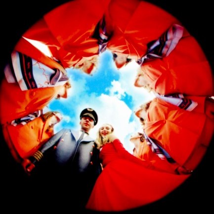 Cabin crew in orange uniforms, fisheye shot from below