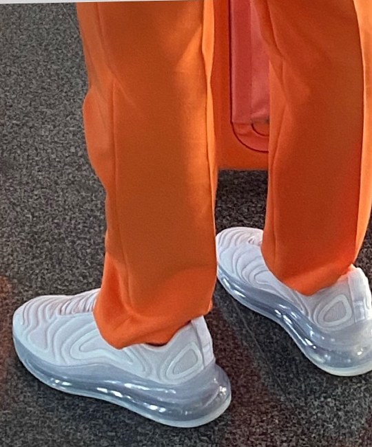 White sneakers with the orange uniform trousers