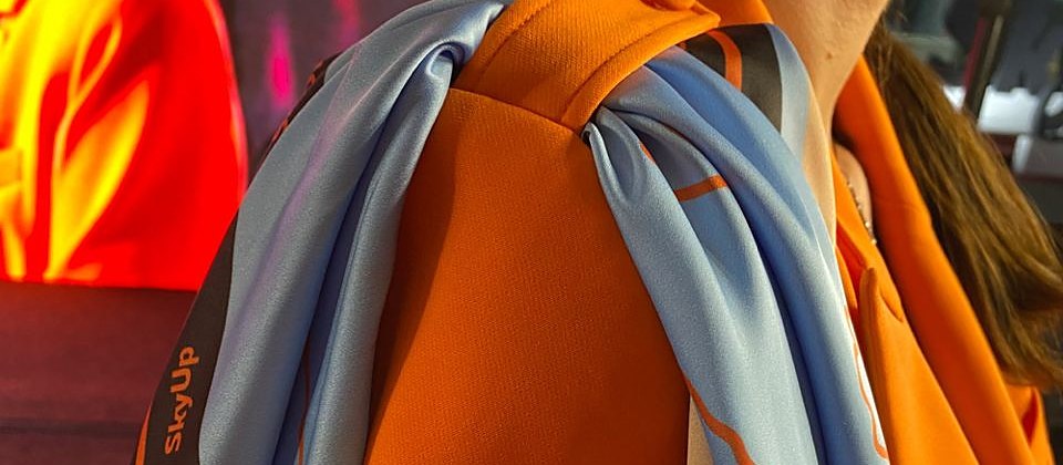 The real SkyUp uniform scarf on the orange jacket