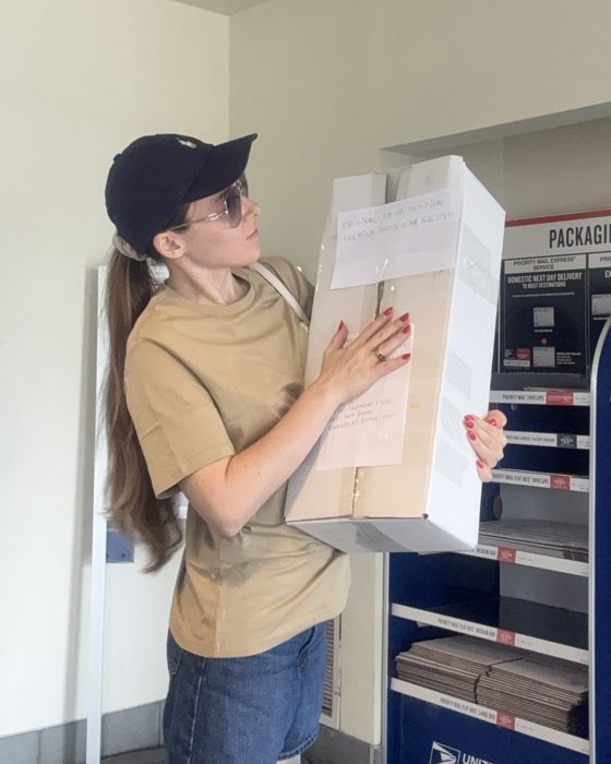 Angelika at the post office with the petition box